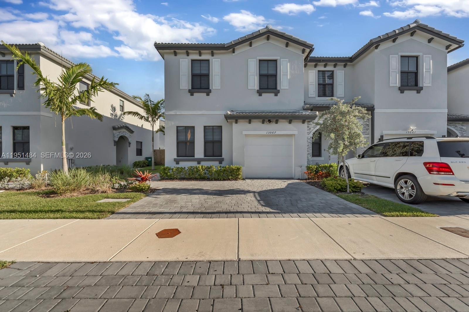 13067 Southwest 286th Street, Unit 13067 Homestead, FL 33033 - Photo 31 of 37 a view of a car park front of house