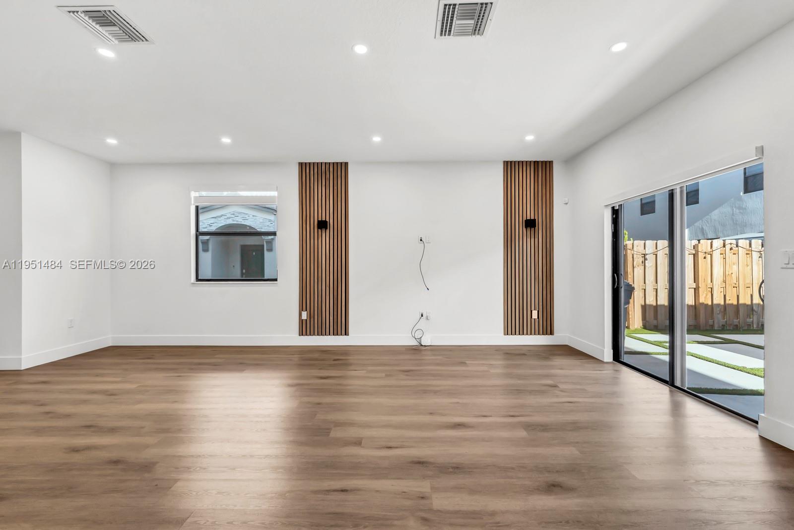 13067 Southwest 286th Street, Unit 13067 Homestead, FL 33033 - Photo 7 of 37 a view of an empty room with wooden floor and a window
