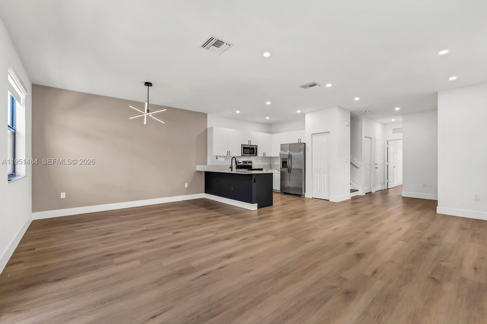 13067 Southwest 286th Street, Unit 13067 Homestead, FL 33033 - Photo 8 of 37 a view of a kitchen with a refrigerator and a sink