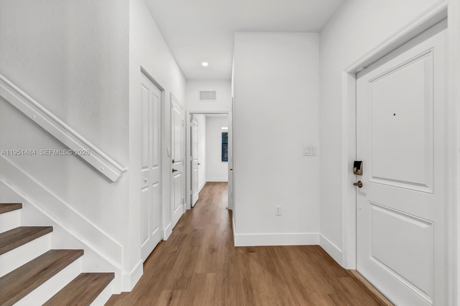 13067 Southwest 286th Street, Unit 13067 Homestead, FL 33033 - Photo 10 of 37 a view of a hallway with wooden floor and entryway