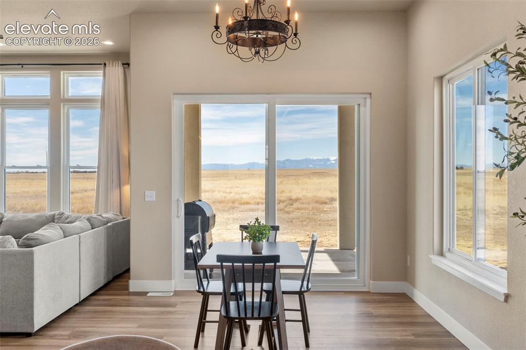 2480 North Log Road Calhan, CO 80808 - Photo 11 of 50 Dining area with custom lighting walks out to covered patio