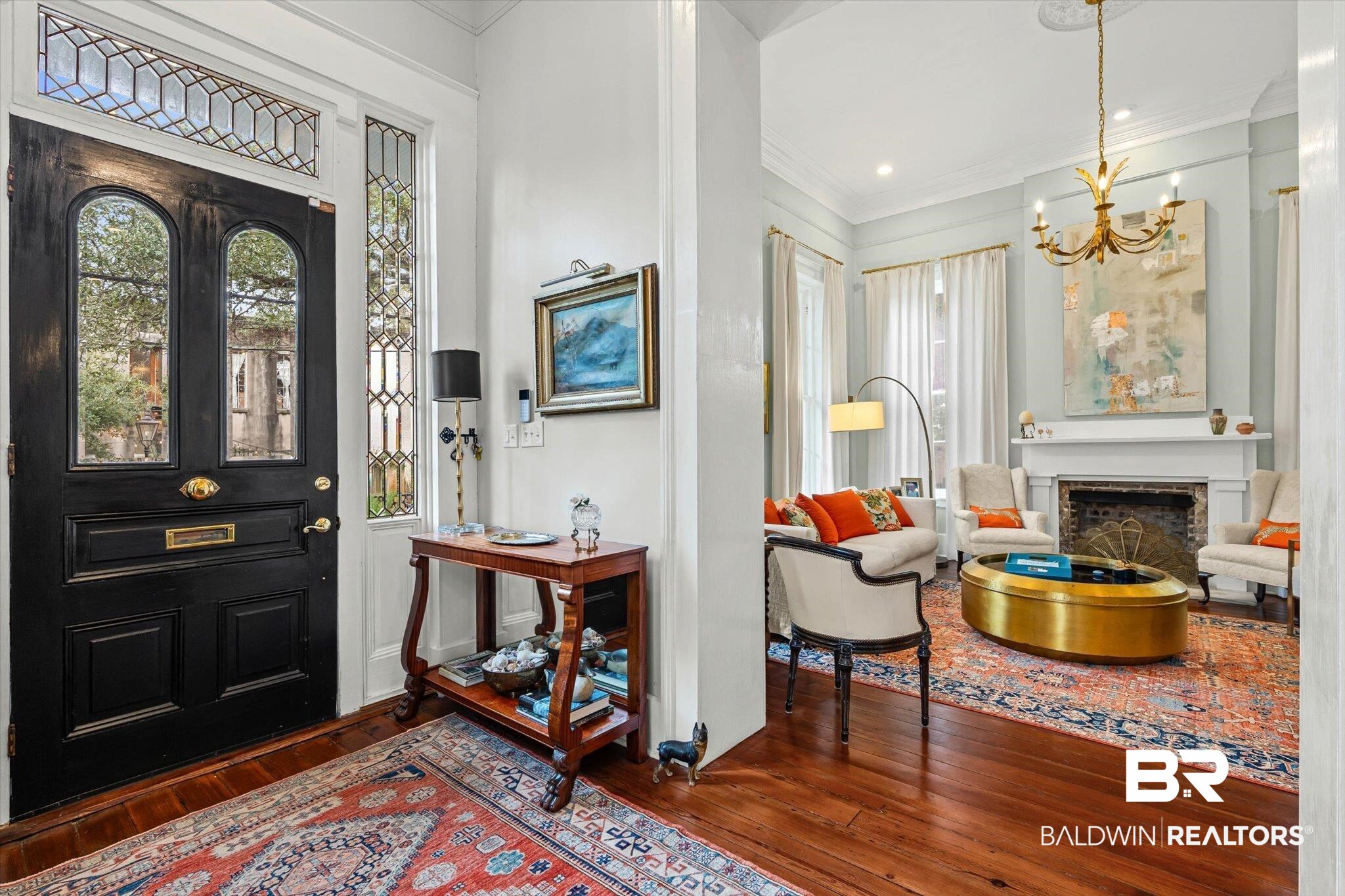 259 North Jackson Street Mobile, AL 36603 - Photo 3 of 42 Entryway featuring dark wood-type flooring, ornamental molding, a fireplace, and a chandelier