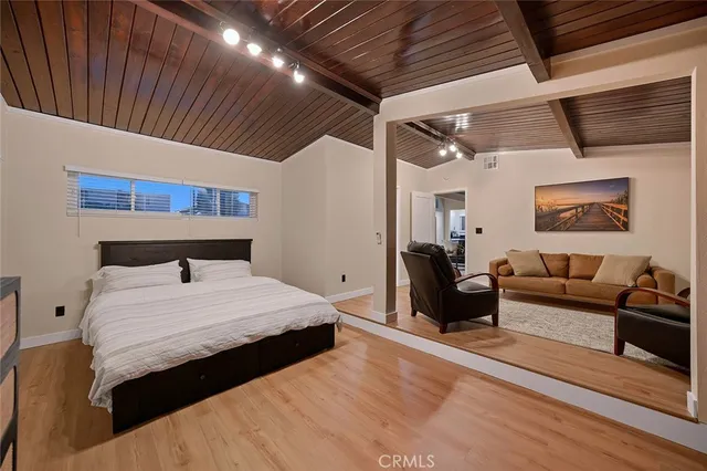 a bedroom with a bed and a couch