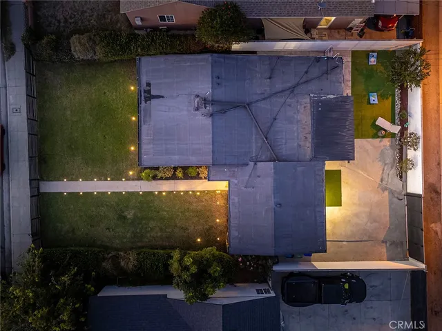 an aerial view of a house with a yard