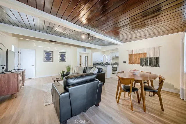 a living room with furniture a wooden floor and a chandelier