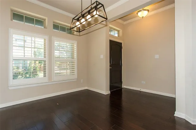 a view of a livingroom with wooden floor and windows