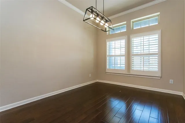 a view of a livingroom with wooden floor and a window
