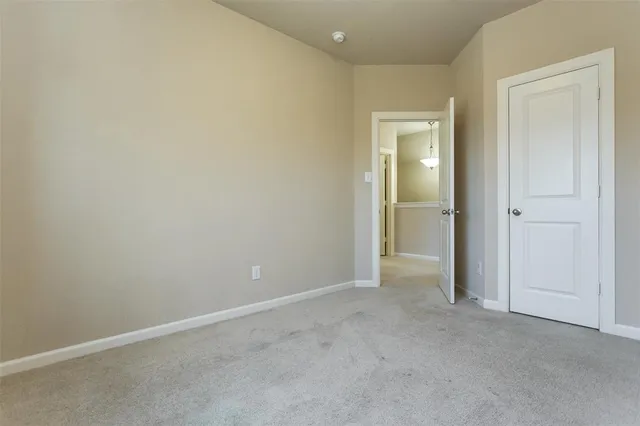 a view of an empty room and closet area
