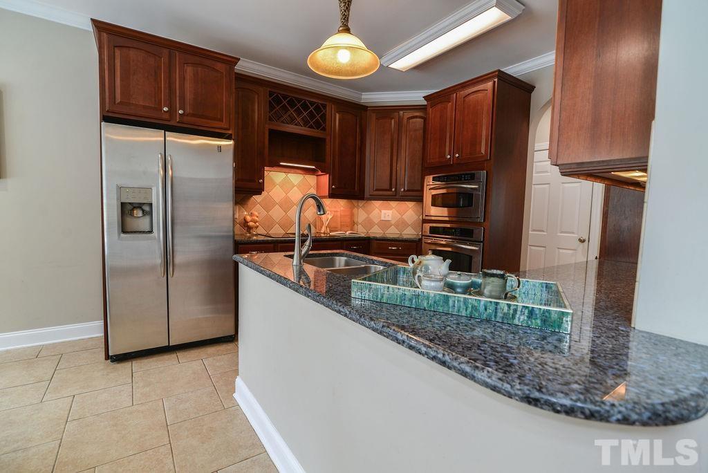 1308 Pagan Road Raleigh, NC 27603 - Photo 14 of 30 a kitchen with stainless steel appliances granite countertop a refrigerator and a sink