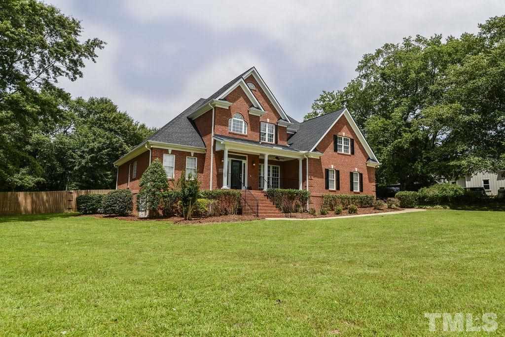 1308 Pagan Road Raleigh, NC 27603 - Photo 3 of 30 a front view of a house with a yard and trees