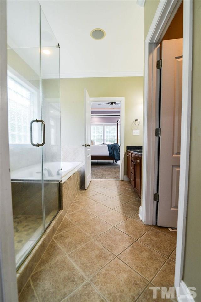 1308 Pagan Road Raleigh, NC 27603 - Photo 22 of 30 a view of a bathroom with a tub mirror and window