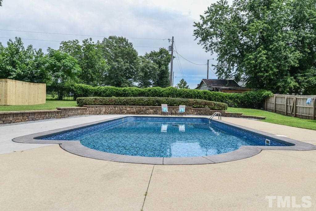 1308 Pagan Road Raleigh, NC 27603 - Photo 8 of 30 a view of a swimming pool with a patio