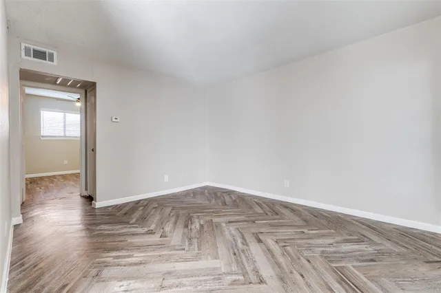 a view of a room with wooden floor