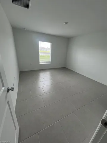 a large kitchen with a large counter top appliances and cabinets