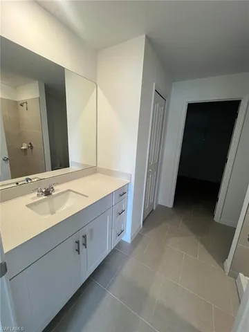 a view of an empty room and a kitchen