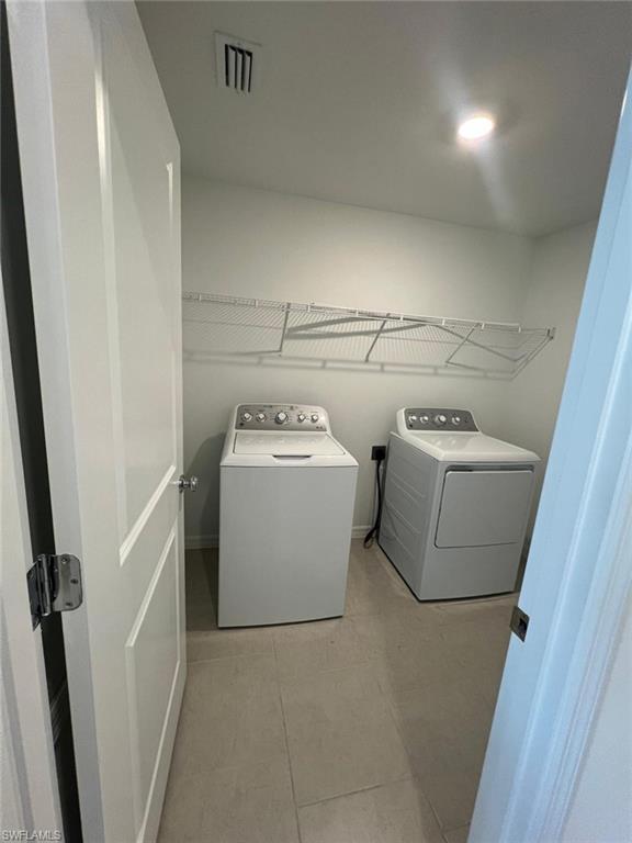 19712 Lavender Field Court Lehigh Acres, FL 33936 - Photo 13 of 17 a utility room with dryer and washer
