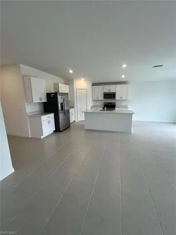 a kitchen with cabinets and stainless steel appliances