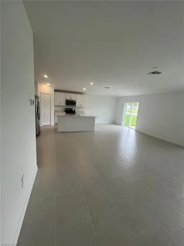 a kitchen with stainless steel appliances a refrigerator sink microwave and cabinets