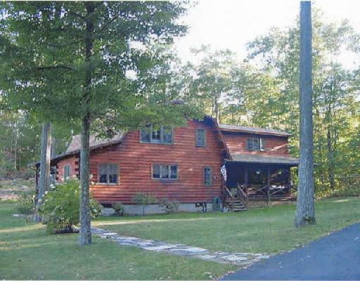 a view of a house with a backyard