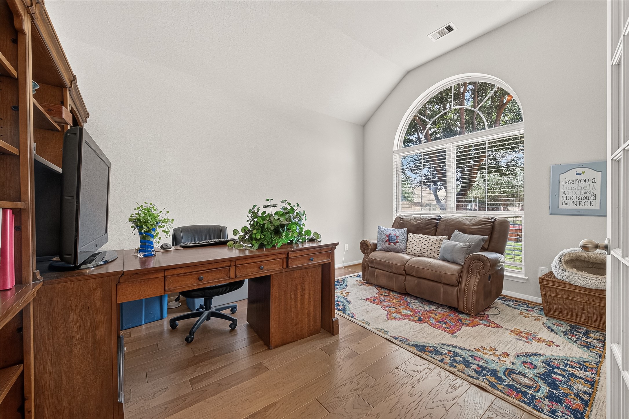 4910 Culver Lane Rosenberg, TX 77471 - Photo 2 of 50 This home office/study features a large arched window allowing plenty of natural light, creating an inviting workspace.