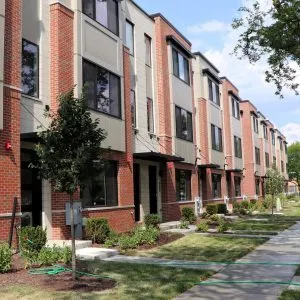 a front view of a building with a garden