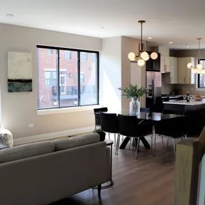 a living room with furniture wooden floor and a large window