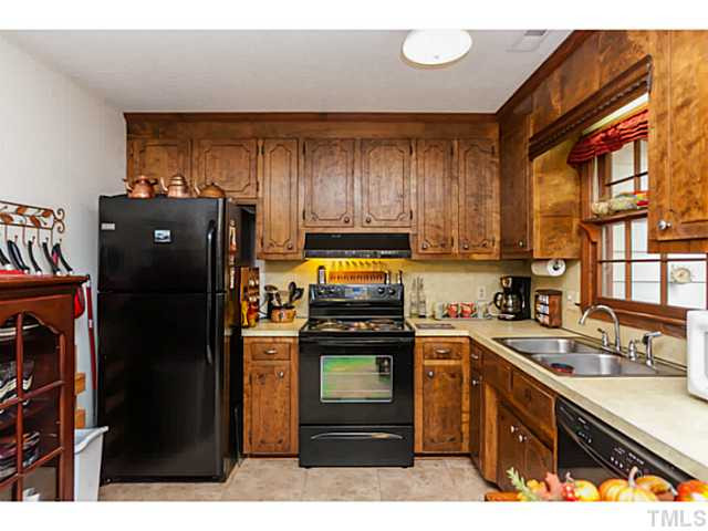 503 Corwin Road Garner, NC 27529 - Photo 8 of 23 a kitchen with a refrigerator stove and sink