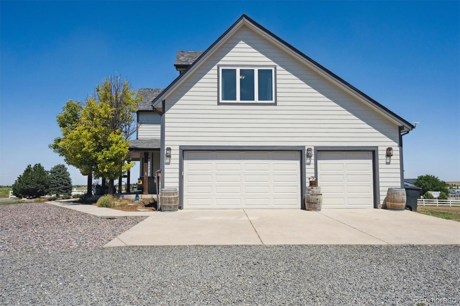 724 Imboden Road Watkins, CO 80137 - Photo 41 of 50 a front view of a house with a yard and garage