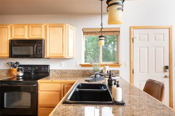 a bedroom with a large bed and a flat tv screen on dresser