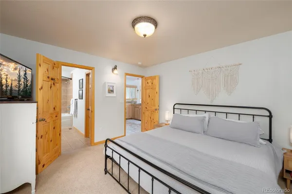 a bathroom with a granite countertop tub a double vanity sink and a mirror