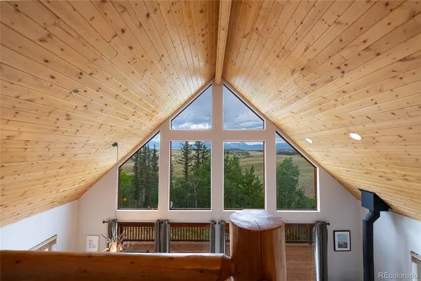 a balcony with furniture and a potted plant