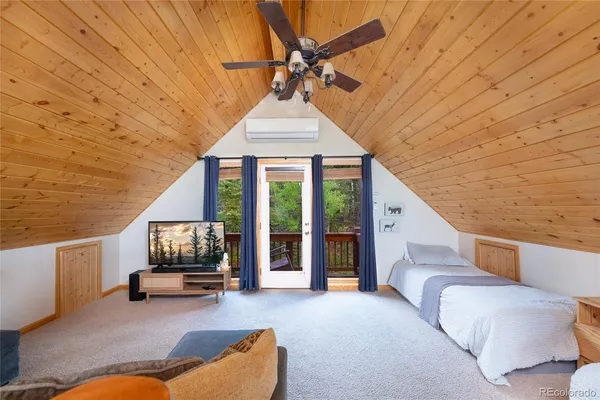a bedroom with a bed and a tv on table