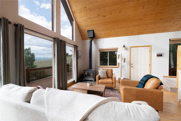 a living room with furniture a table and a large window
