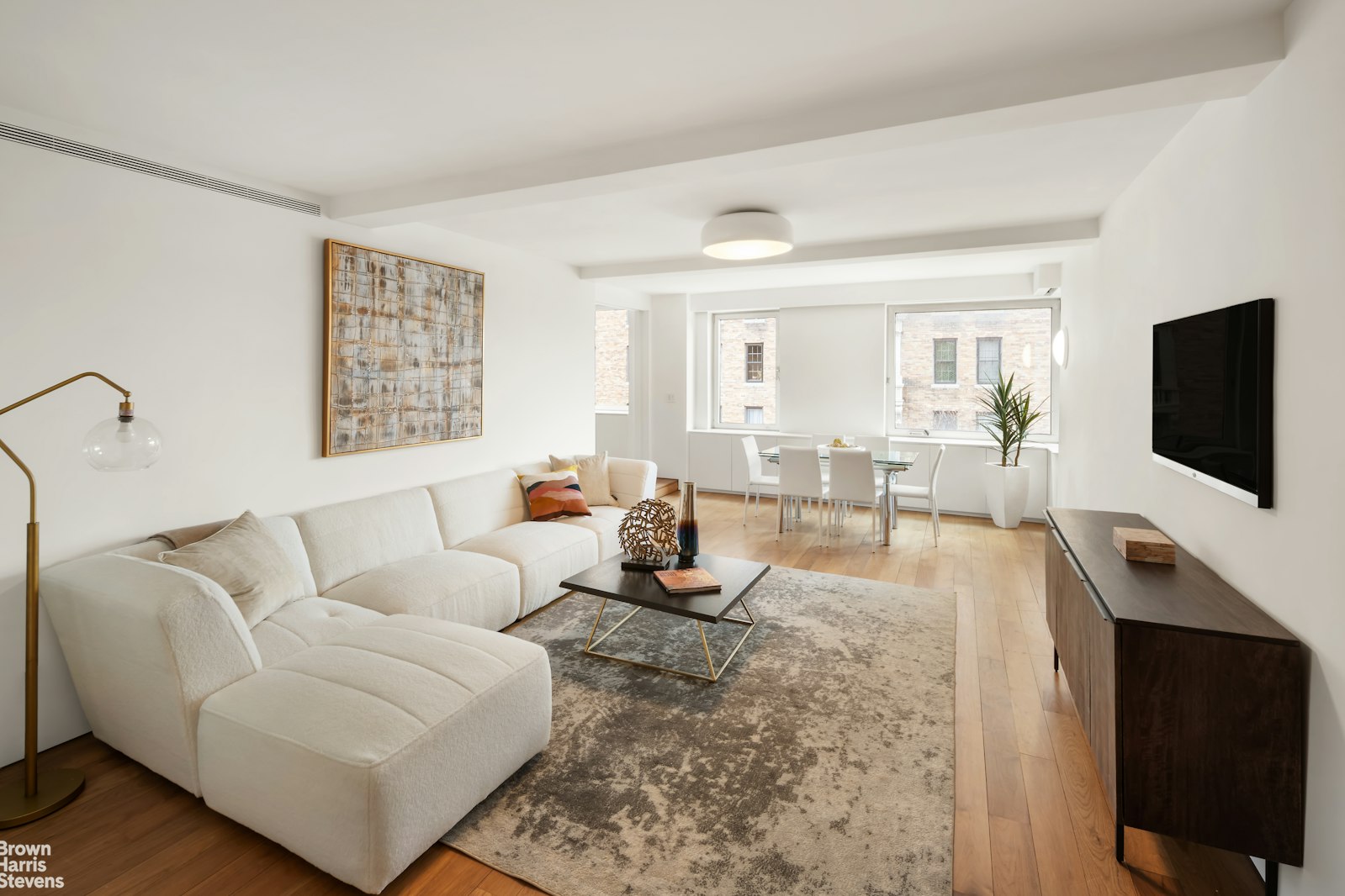 100 Riverside Drive, Unit 6D Manhattan, NY 10024 - Photo 1 of 1 a living room with furniture and a flat screen tv