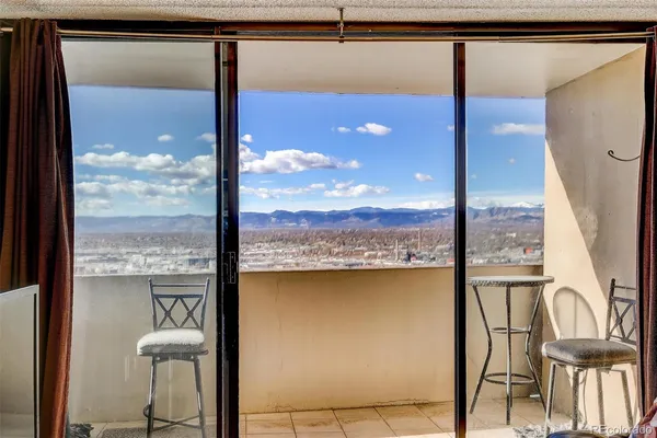 a view of a balcony with chair and floor to ceiling window