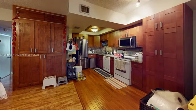 a view of kitchen with furniture and wooden floor