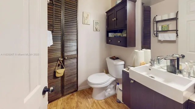 a bathroom with a sink a toilet and shower curtain