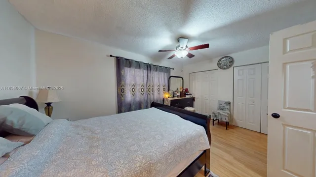 a bed room with a bed mirror and a chandelier