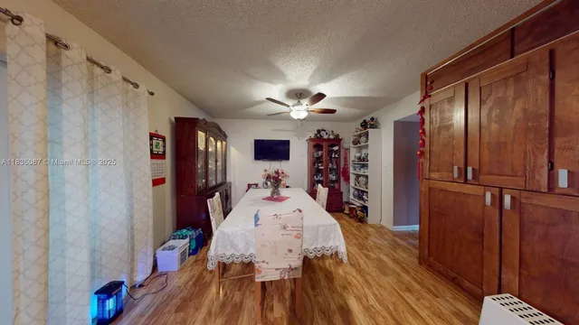 a very nice looking room with wooden floor and furniture