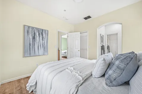 a bedroom with a bed and a couch