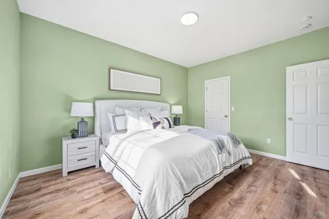 a bedroom with a bed and a night stand