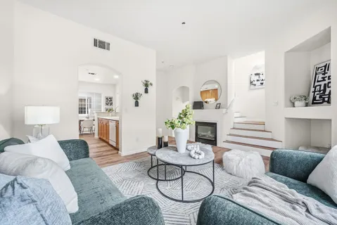 a living room with furniture and a fireplace