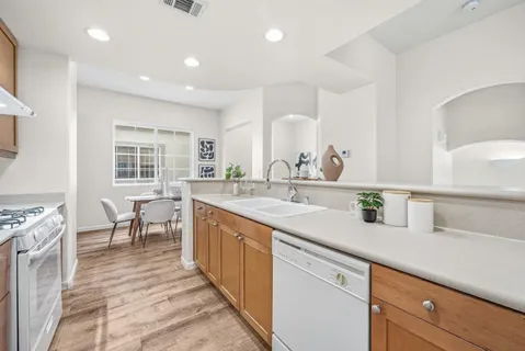 a large kitchen with kitchen island a sink stainless steel appliances and cabinets
