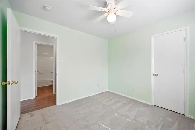 a view of an empty room and wooden floor