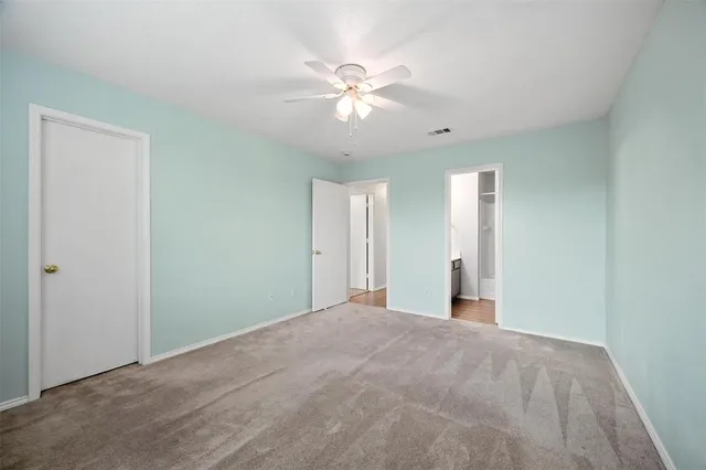 a view of a livingroom with a ceiling fan and a window