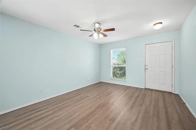wooden floor in an empty room with a window