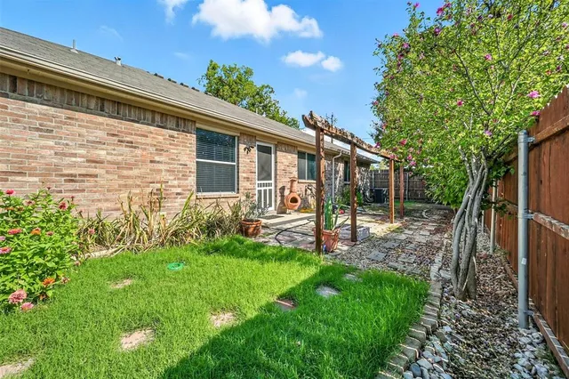 a view of a house with a backyard and a patio