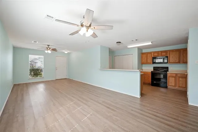 a view of a kitchen with a sink and a stove top oven