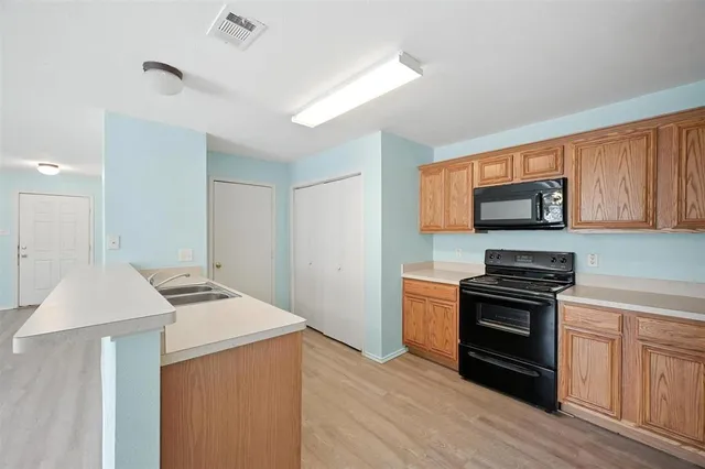 a kitchen with granite countertop stainless steel appliances and wooden cabinets