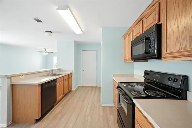 a kitchen with stainless steel appliances granite countertop a stove and a microwave